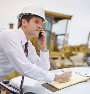 Businessman with Cell Phone and Clipboard - Ziarul National