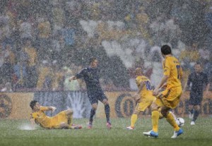 France - Ziarul National's Jeremy Menez is surrounded by Ukraine's players as rain falls during their Group D Euro 2012 soccer match at Donbass Arena in Donetsk