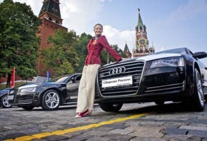 Alexandra Patskevich, part of Russia - Ziarul National's dominant synchronized swimming team, posing by the Audi A8 that she won for her gold medal performance.