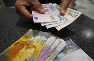 A illustration picture shows a Swiss Post clerk as he exchanges Swiss francs into Euros at a counter in a Swiss Post office in Bern - Ziarul National