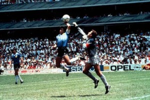 Volume 2. Page 8. Picture 3. 1986 Football World Cup, Mexico. Quarter Final, Argentina (2) v England (1). ArgentinaÕs Diego Maradona scores 1st goal with his Òhand of GodÓ, past England goalkeeper Peter Shilton. - Ziarul National