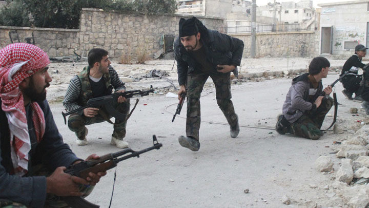 Free Syrian Army fighters take positions during what the FSA said were clashes with forces loyal to Syria - Ziarul National's President Bashar al-Assad in Aleppo's Karm al-Jabal district