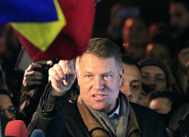 Romanian presidential candidate Klaus Iohannis celebrates his victory in the election run-off, with protesters in central Bucharest - Ziarul National
