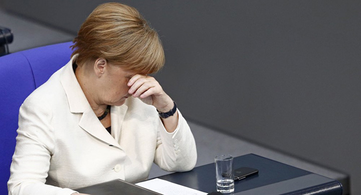 Merkel, pusa la zid