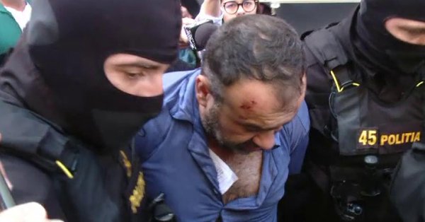 Criminalul poliţistului din Timiş, adus încătuşat la audieri (VIDEO)
