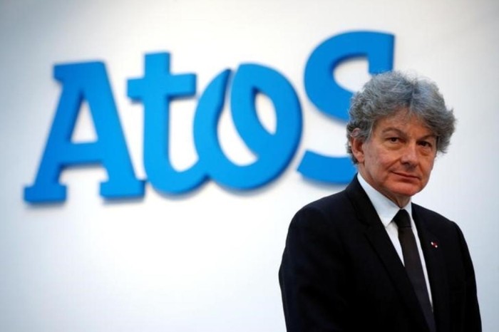 FILE PHOTO: Atos Chairman and CEO Thierry Breton poses in front of the company's logo during a presentationin Paris - Ziarul National