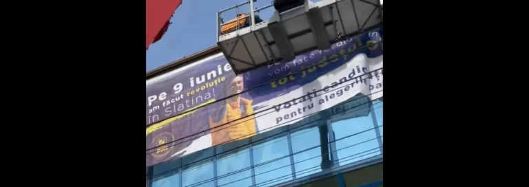 PNL Slatina şi primarul De Mezzo, din nou în ilegalitate: Banner uriaş ilegal cu Nicolae Ciucă amplasat pe sediul partidului